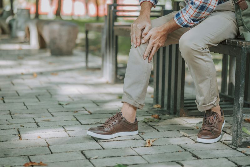 a man out in the park with knee pain
